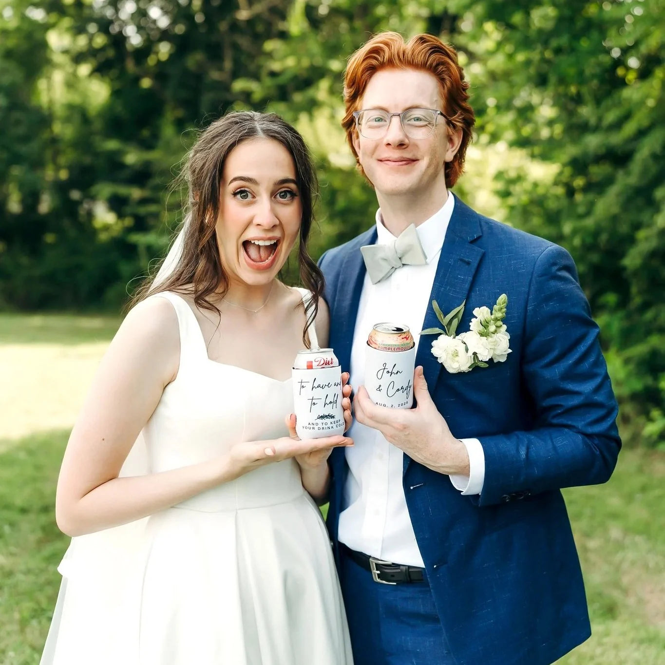 A newlywed couple holding their personalized wedding can coolers