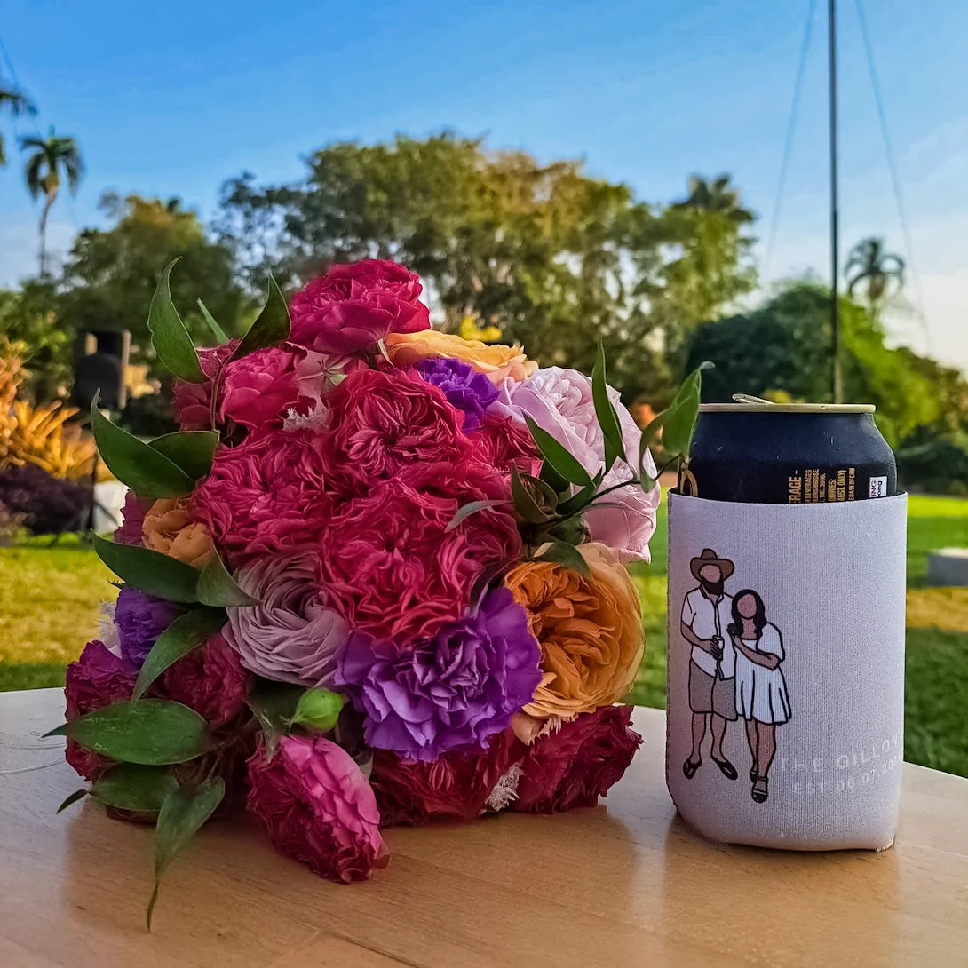 A portrait can cooler beside a colorful wedding bouquet
