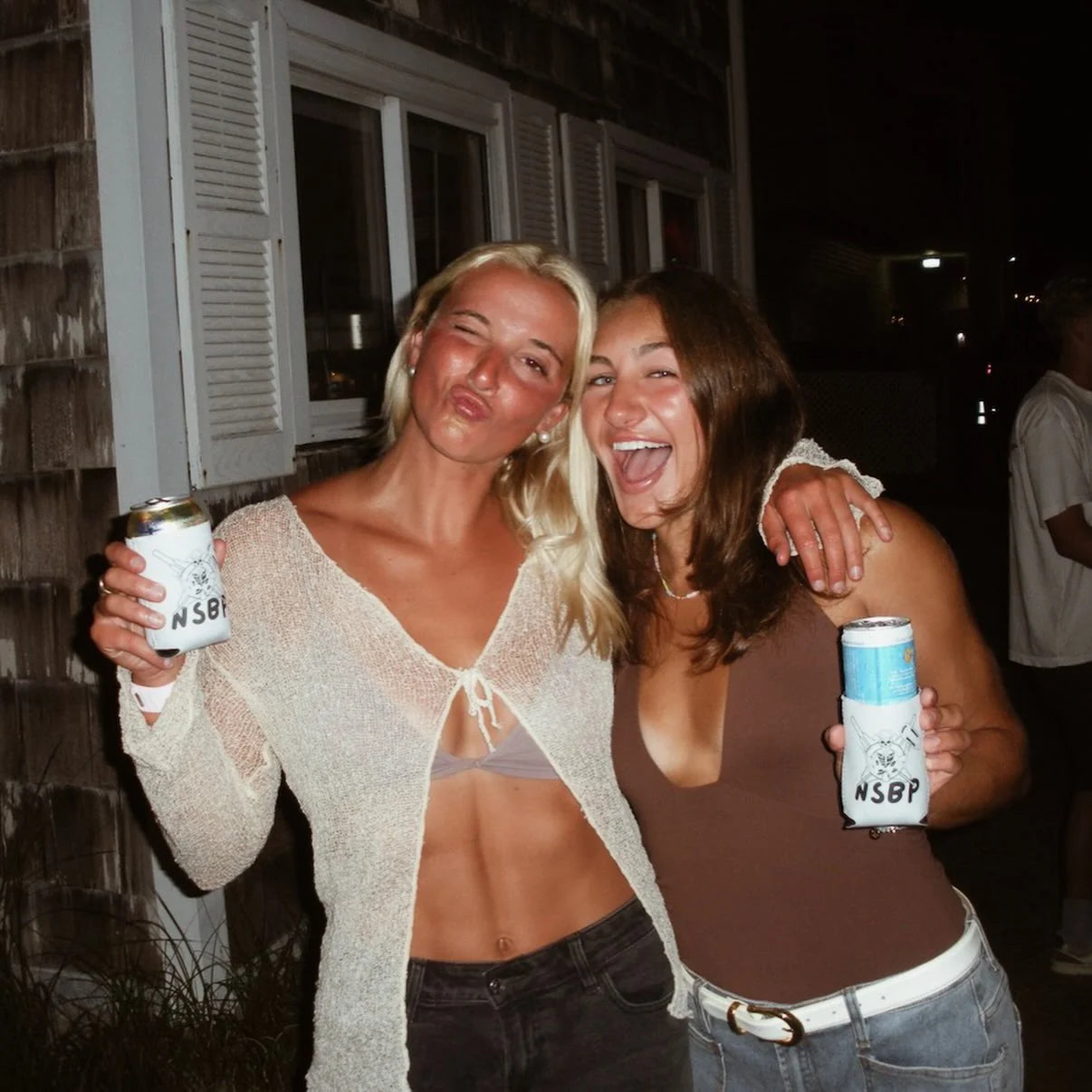Friends holding personalized can coolers at a celebration
